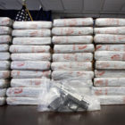 FILE - This Tuesday, May 19, 2015 file photo shows a firearm and 154 pounds of heroin worth at least $50 million displayed during a Drug Enforcement Administration news conference in New York. According to government data released Thursday, Dec. 8, 2016, drug overdose deaths in the U.S. surpassed 50,000 in 2015, the highest mark in at least 15 years. (AP Photo/Mark Lennihan)